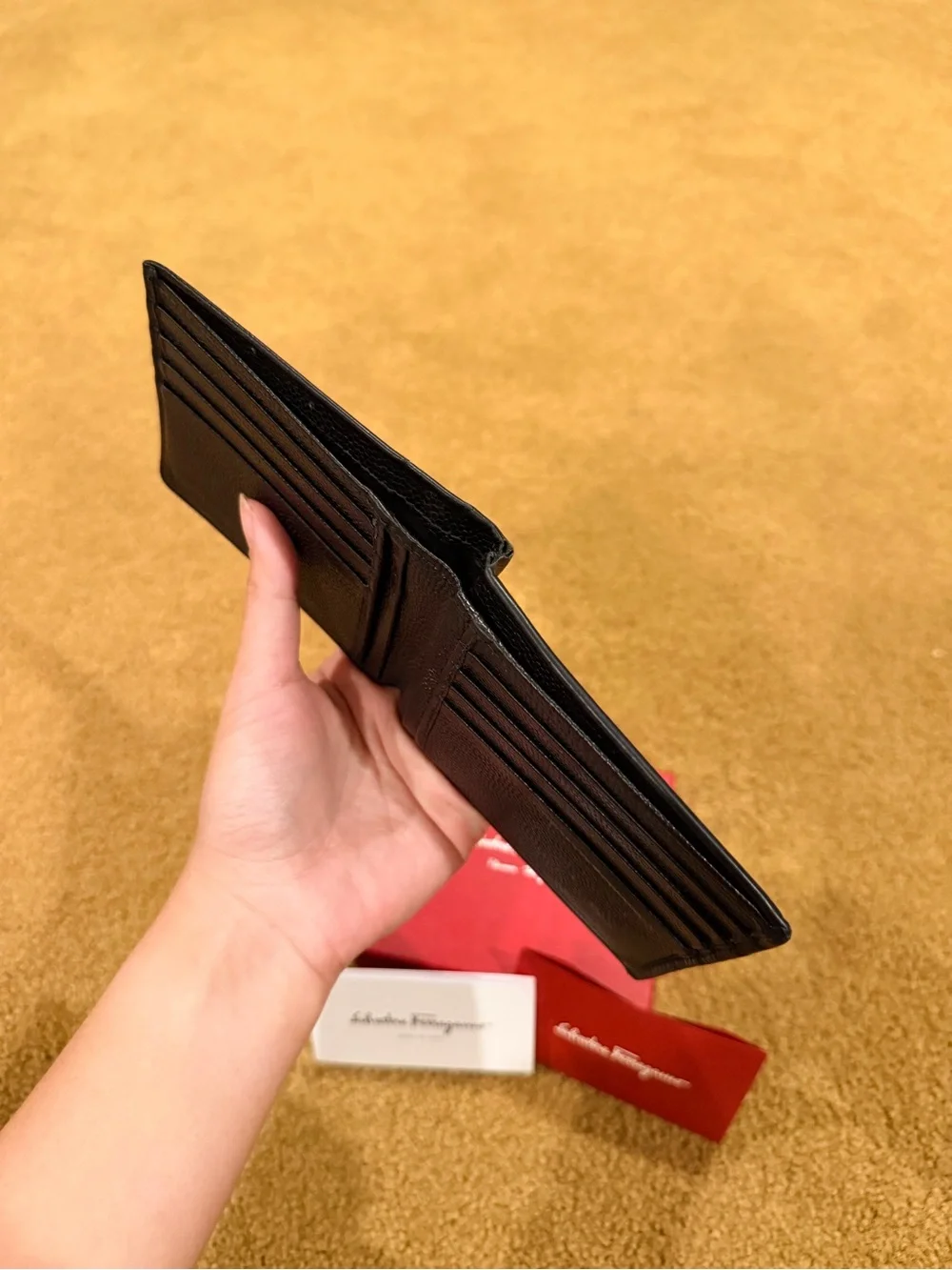 Salvatore Ferragamo Black Pebbled Leather Bi-Fold Wallet with Metal Logo